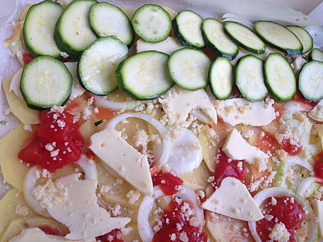 layered baked vegetables with cheese and tomato